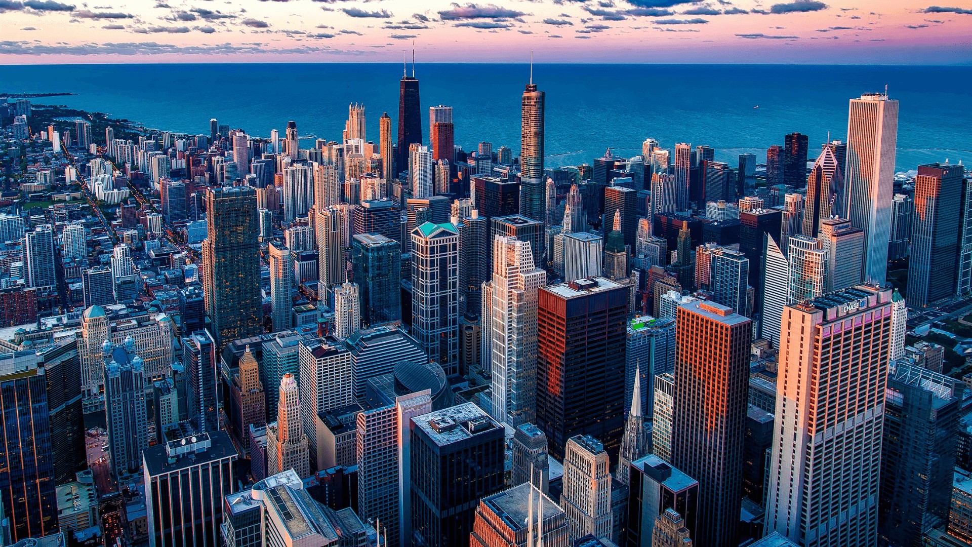 an aerial view of the Chicago skyline at sunset
