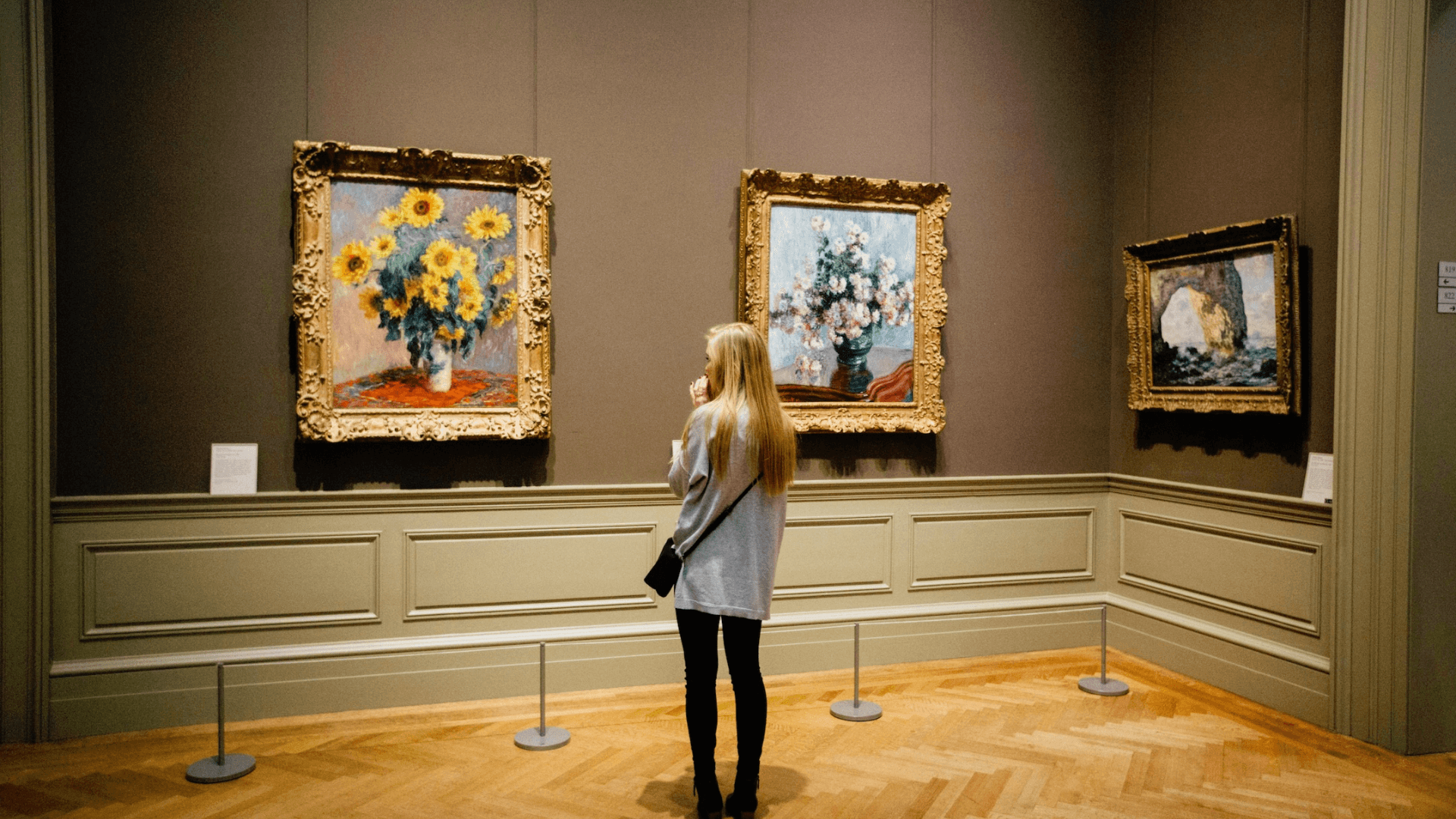 a girl staring at a painting